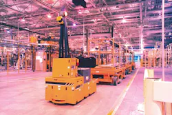 A tow-style AGV works in a Ford plant. A tow-style AGV works in a Ford plant.
