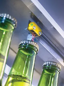 This photoelectric sensor inspects for the presence of bottle caps. This photoelectric sensor inspects for the presence of bottle caps.