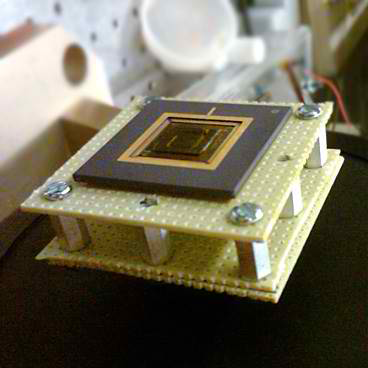 A new energy harvesting device converts low-frequency vibrations into electricity. The device, the size of a U.S. quarter, is sh