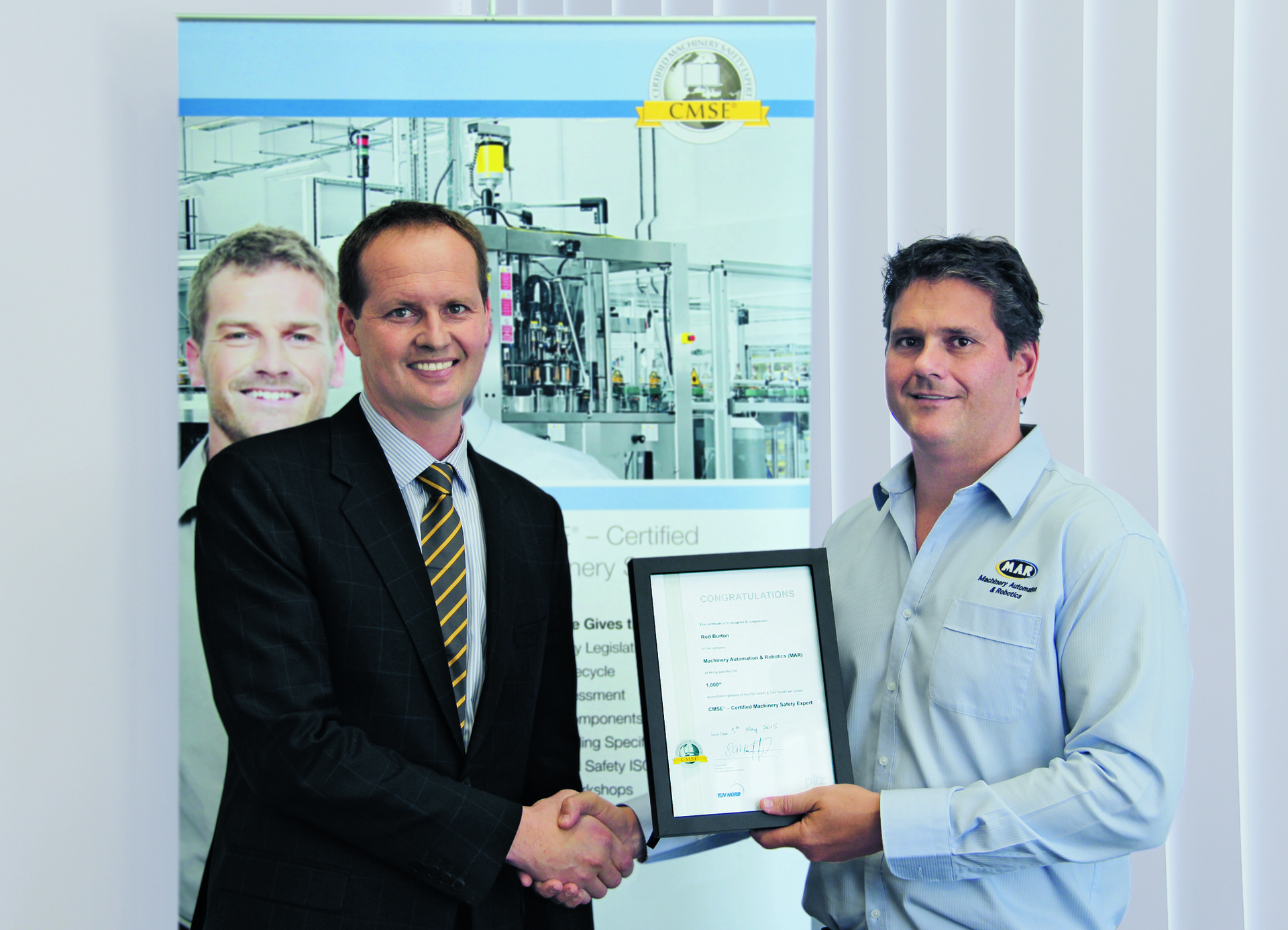 Congratulations: In Sydney, Australia Electrical engineer Rod Burton (right) from Machinery Automation & Robotics, receives the