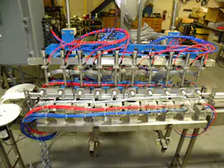 This conveyor-based packaging machine dispenses product to 10 difficult-to-handle oval bottles at a time. This conveyor-based packaging machine dispenses product to 10 difficult-to-handle oval bottles at a time.