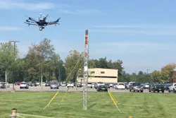 At an outdoor test site at GE Global Research, a drone flies around a small tower to create a 3D model of the asset. At an outdoor test site at GE Global Research, a drone flies around a small tower to create a 3D model of the asset.