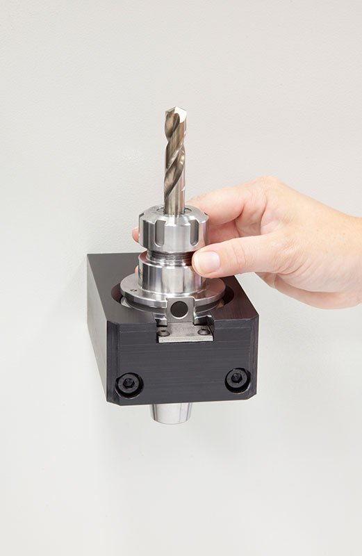 A CNC operator on the shop floor puts the tool&rsquo;s holder in an RFID read station and then the tag is read by the ToolConnect system.