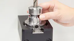 A CNC operator on the shop floor puts the tool’s holder in an RFID read station and then the tag is read by the ToolConnect system.