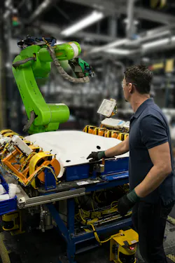A CR-35iA collaborative robot from Fanuc working in tandem with a technician on an automotive headliner gluing application. A CR-35iA collaborative robot from Fanuc working in tandem with a technician on an automotive headliner gluing application.