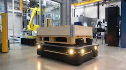 Top load mobile robot delivering pallet to robotic workcell.
