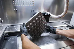 Removing a DMLS print from the powder. Removing a DMLS print from the powder.