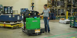 A warehouse employee programs a Vecna Robotics ATG Autonomous Tugger for its next task on the shop floor. Source: Vecna Robotics A warehouse employee programs a Vecna Robotics ATG Autonomous Tugger for its next task on the shop floor. Source: Vecna Robotics