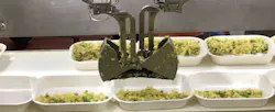 Chef Robotics' flexible automation system deposits ingredients into food trays at Amy's Kitchen. Top row of trays were filled by humans while bottom trays in foreground were filled by the Chef Robotics system. Source: Chef Robotics Chef Robotics' flexible automation system deposits ingredients into food trays at Amy's Kitchen. Top row of trays were filled by humans while bottom trays in foreground were filled by the Chef Robotics system. Source: Chef Robotics