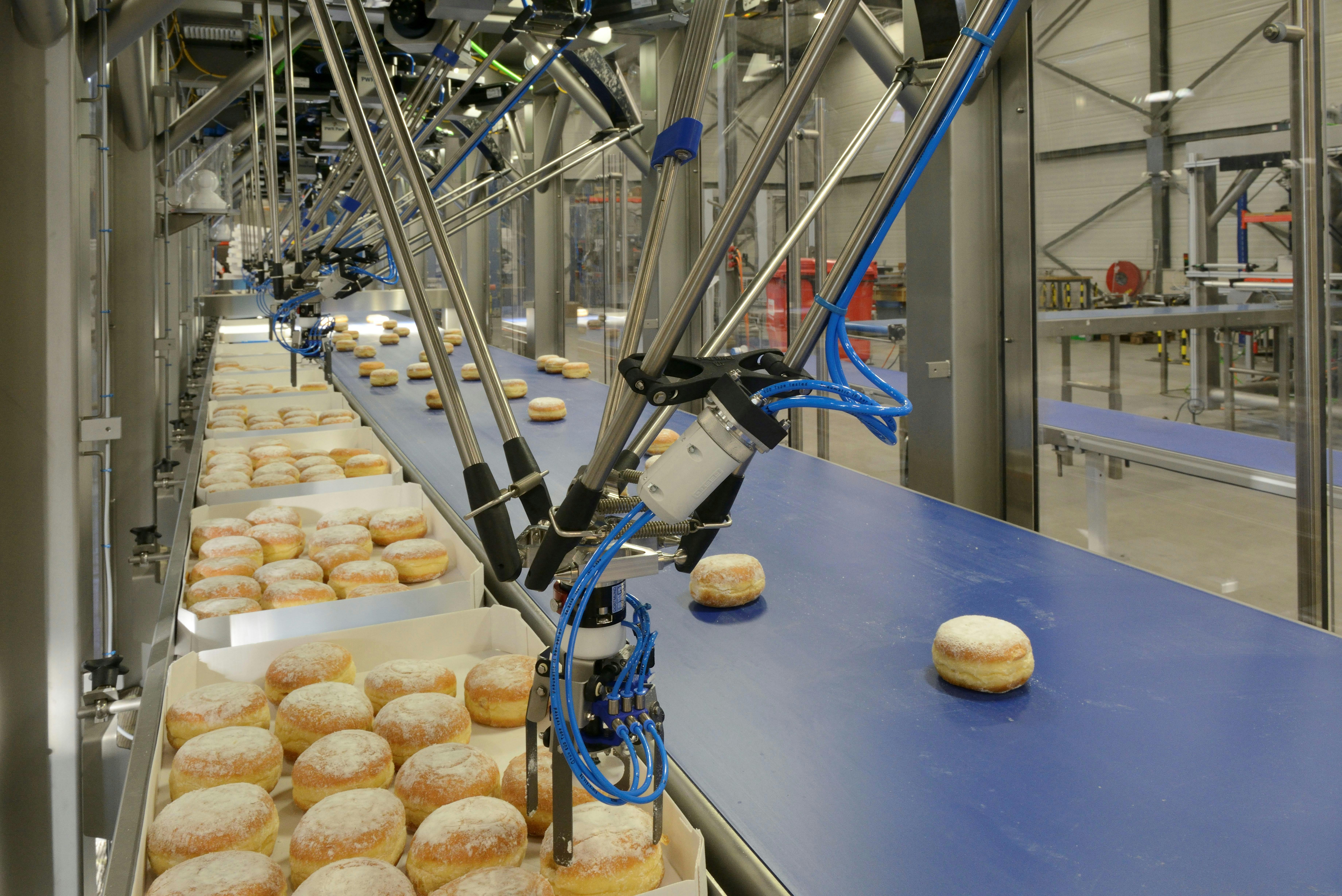 An automated high-speed pick-and-place system utilized on a production line for donuts and berliners.