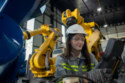 Engineer reviewing robotic workcell Engineer reviewing robotic workcell