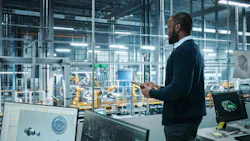 Engineer using AI at manufacturing facility Engineer using AI at manufacturing facility