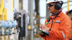 engineer checking devices at a process plant