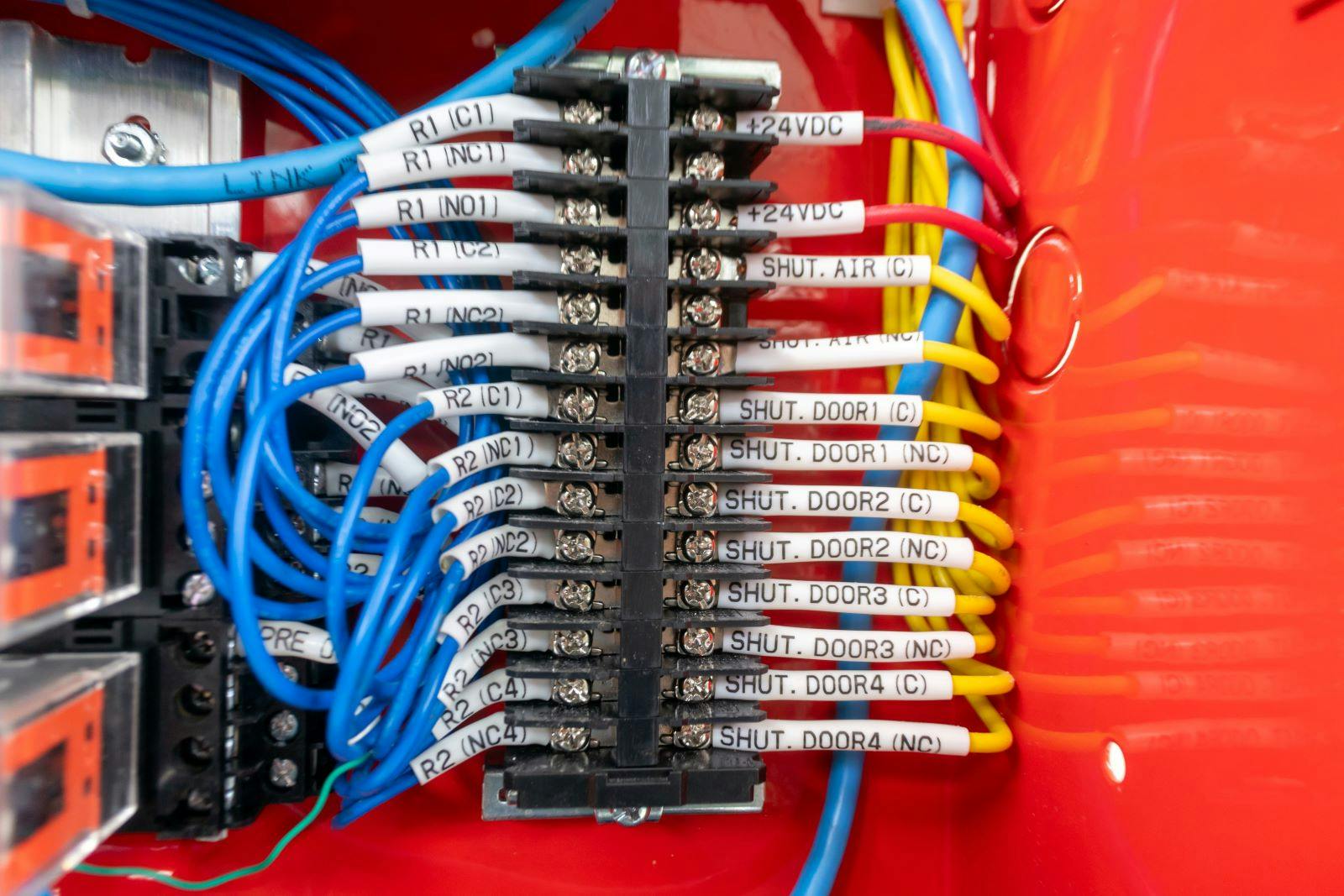 a detailed close-up view of colorful electrical wiring inside a control panel