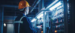 engineer at control equipment panel in industrial facility engineer at control equipment panel in industrial facility