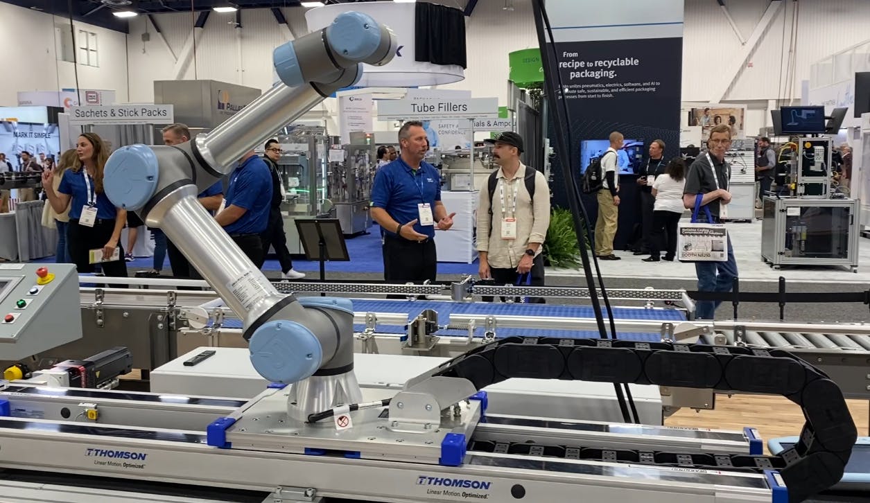 The Movotrak 7th axis system with a Universal Robot cobot attached on display at Pack Expo 2025.