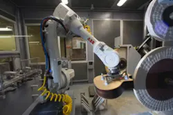 An ABB IRB 4600 robot positions a guitar body against the buffing wheel. An ABB IRB 4600 robot positions a guitar body against the buffing wheel.