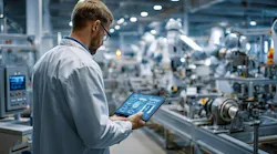 worker reviews production operations data via a consolidated platform