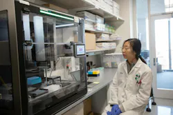 researcher views Opentrons Flex automated lab equipment researcher views Opentrons Flex automated lab equipment