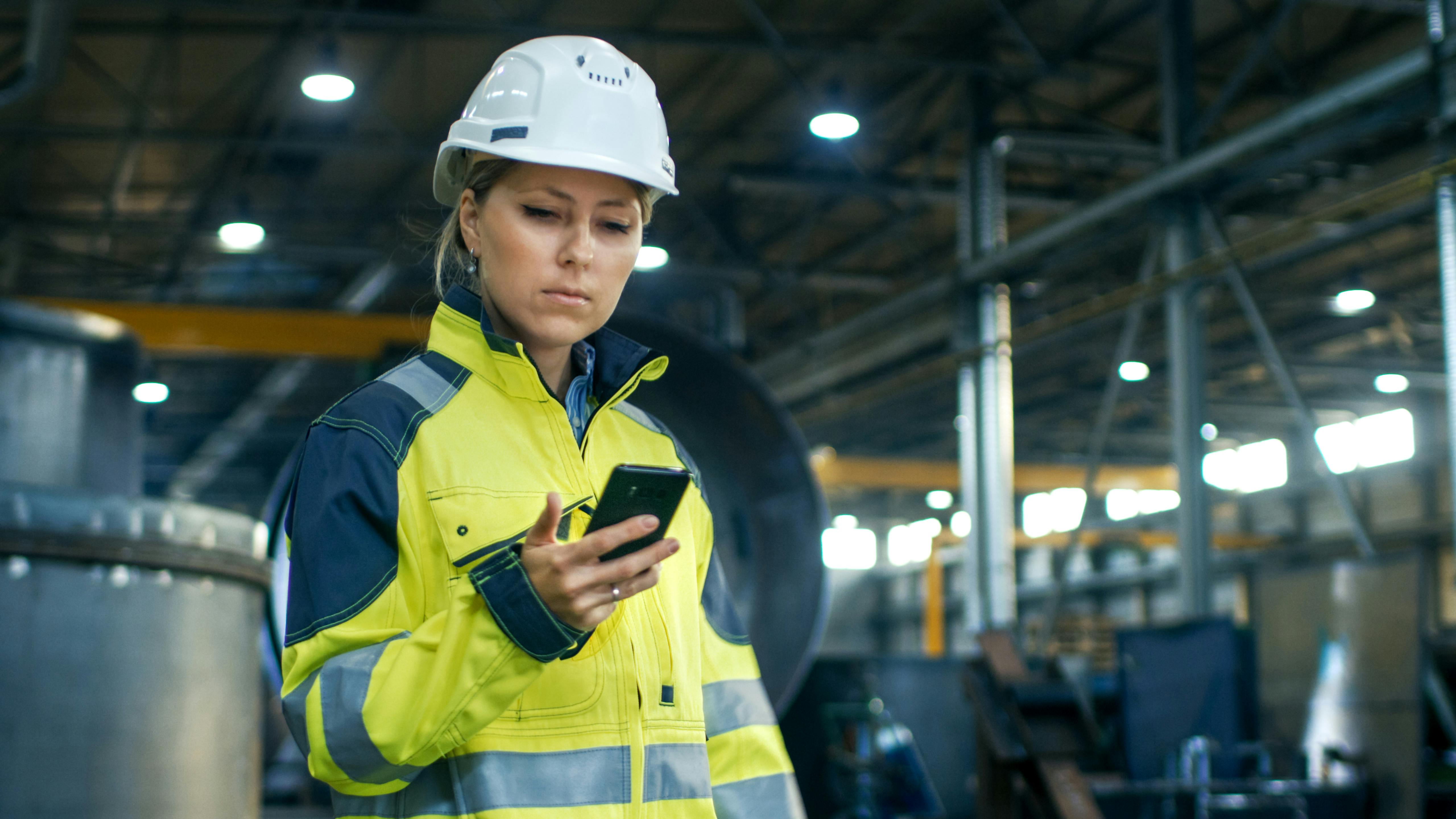 Industrial worker accessing apps on a smartphone