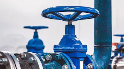 A close-up view of a shut-off valve inside a water pumping station. The setting highlights engineering communications and industrial design, showcasing the functioning components of the system.