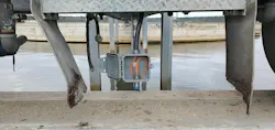 Figure 3: A Contrinex quick-disconnect inductive proximity sensor, sourced from AutomationDirect, rides along with the bridge arm, aimed at the surface below where it can detect metal targets positioned around the circumference of the basin.